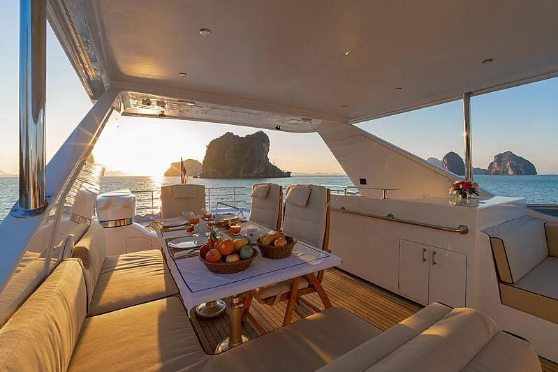 a boat with a table and chairs aboard AJAO Yacht for Sale