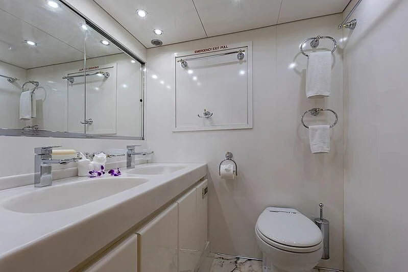 a bathroom with a sink toilet and a mirror aboard AJAO Yacht for Sale
