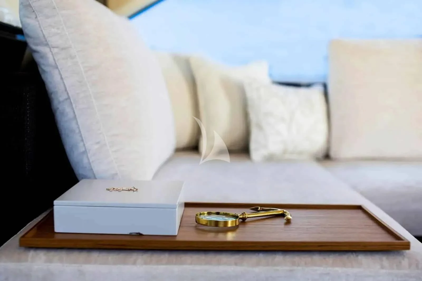 a book and a pen on a table aboard ALKYONE Yacht for Sale