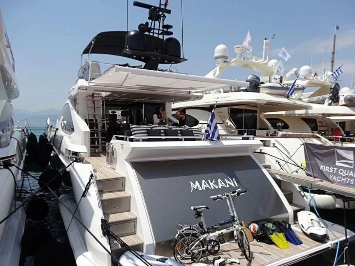 a boat docked with a boat and bicycles on the deck aboard ALKYONE Yacht for Sale
