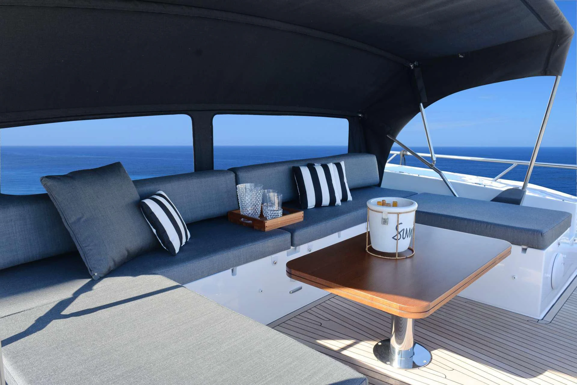a boat with a coffee table and a glass window aboard ALKYONE Yacht for Sale