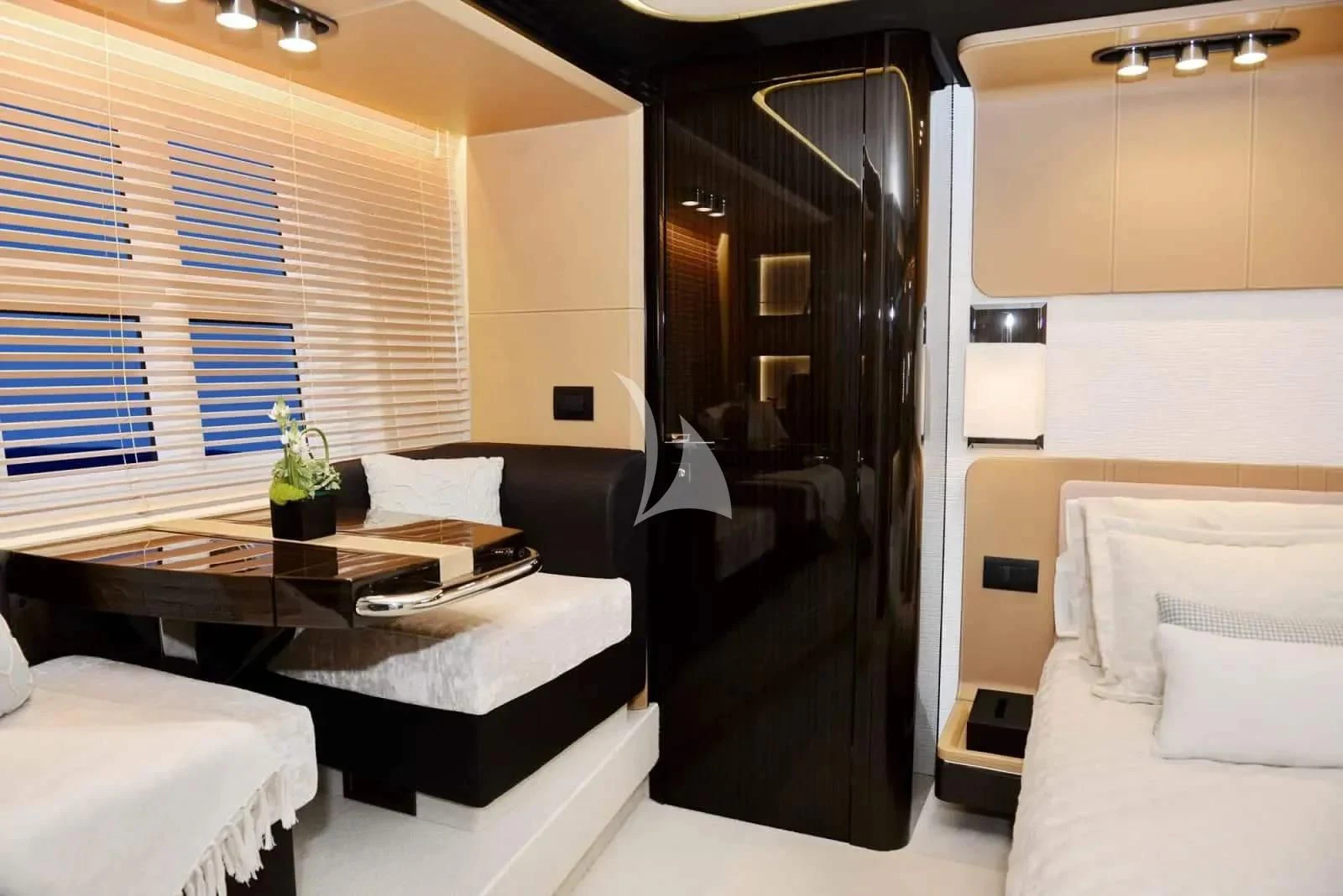 a room with a bed and desk aboard ALKYONE Yacht for Sale
