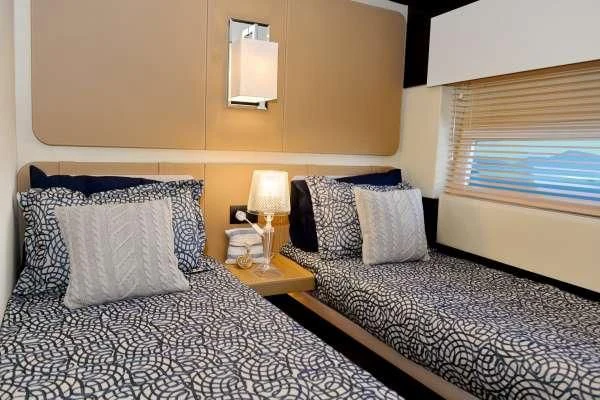 a couple of beds in a hotel room aboard ALKYONE Yacht for Sale