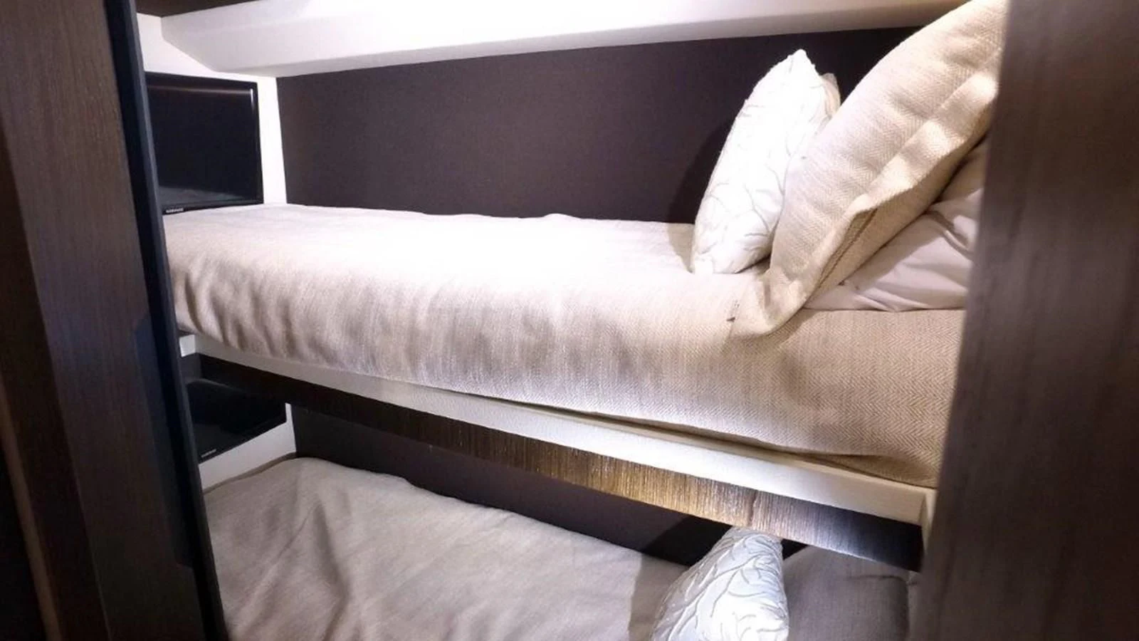 a bed with white sheets aboard LEVATAR Yacht for Sale