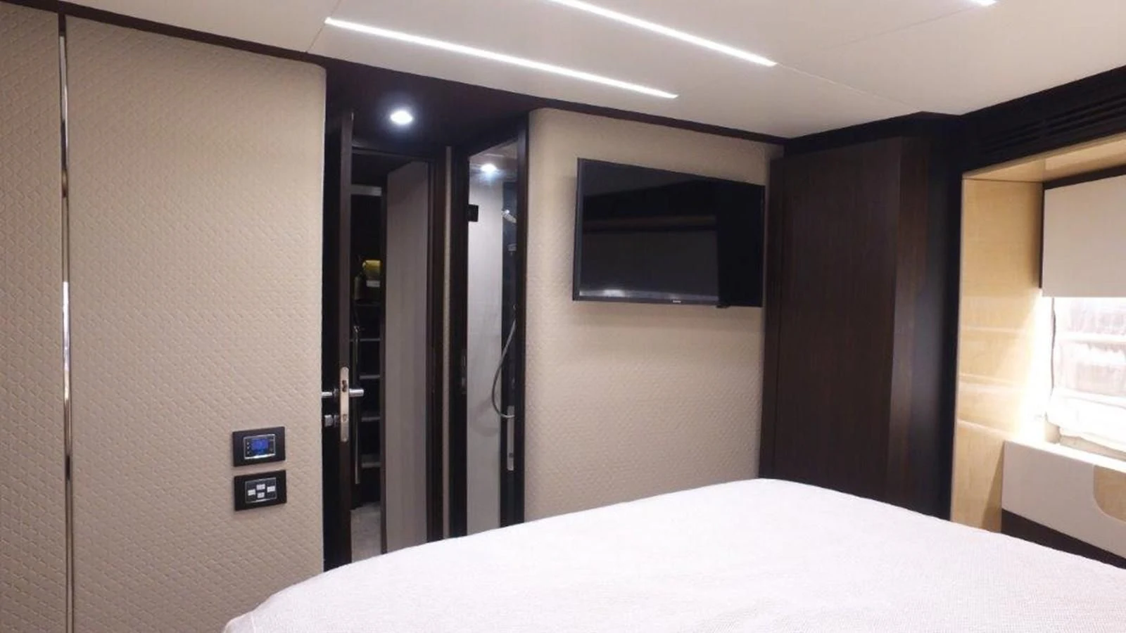 a room with a bed and a desk aboard LEVATAR Yacht for Sale