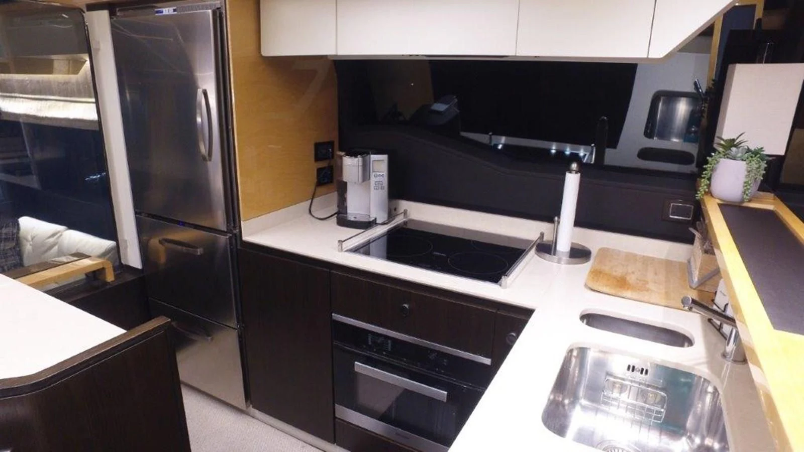 a kitchen with a stainless steel refrigerator aboard LEVATAR Yacht for Sale