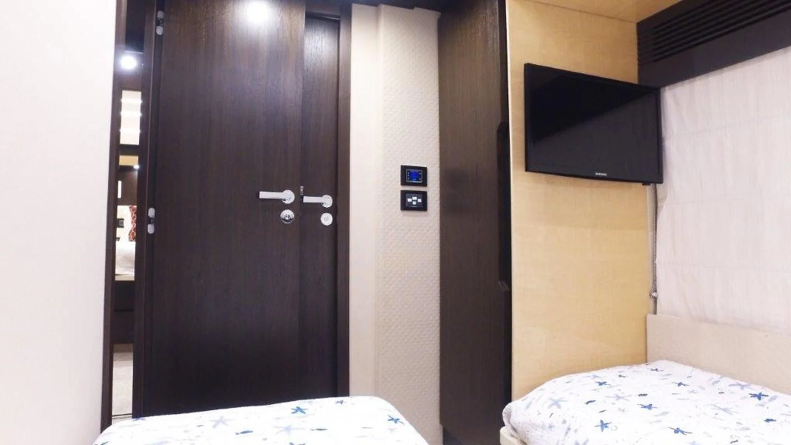 a room with a bed and a television aboard LEVATAR Yacht for Sale