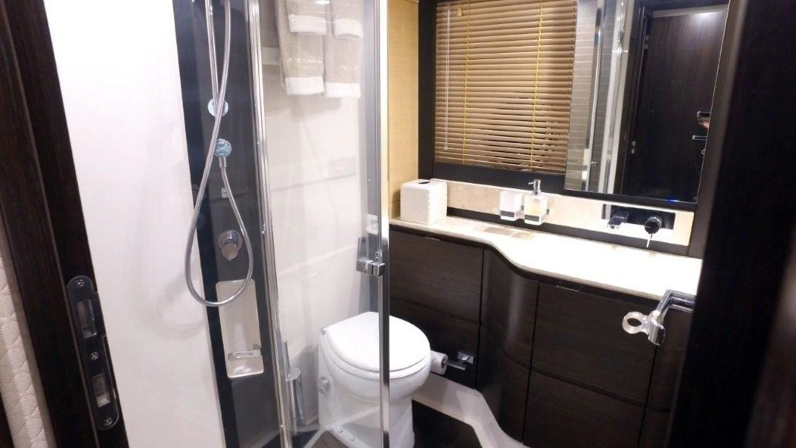 a bathroom with a toilet and a sink aboard LEVATAR Yacht for Sale