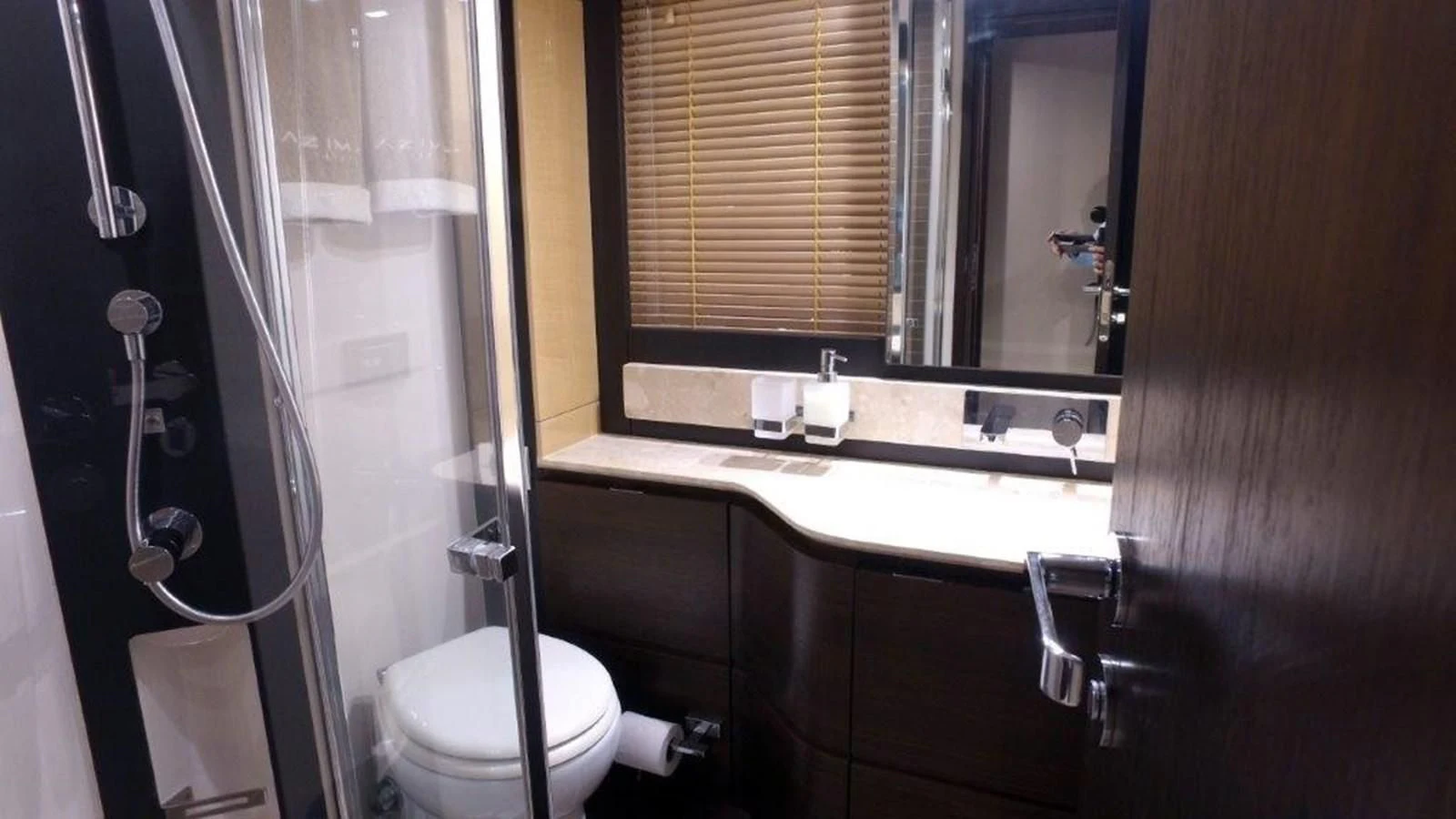 a bathroom with a toilet and a sink aboard LEVATAR Yacht for Sale