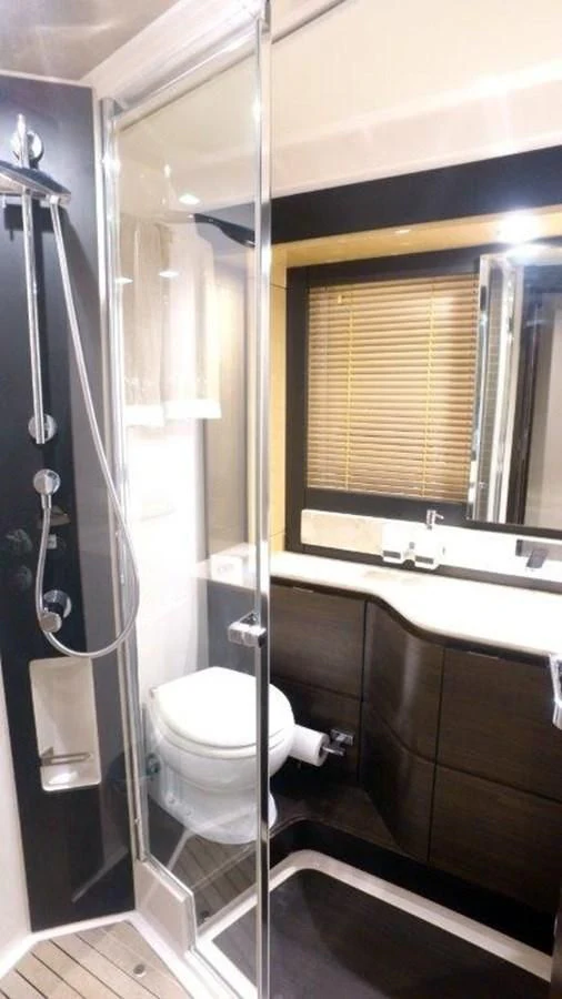 a bathroom with a toilet and a sink aboard LEVATAR Yacht for Sale