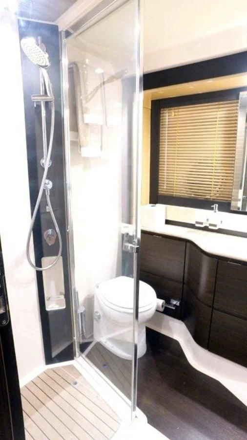 a bathroom with a toilet and a shower unit aboard LEVATAR Yacht for Sale