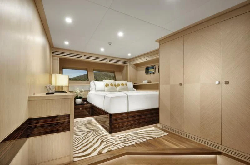 a room with a bed and a desk aboard THAT'S AMORE Yacht for Sale