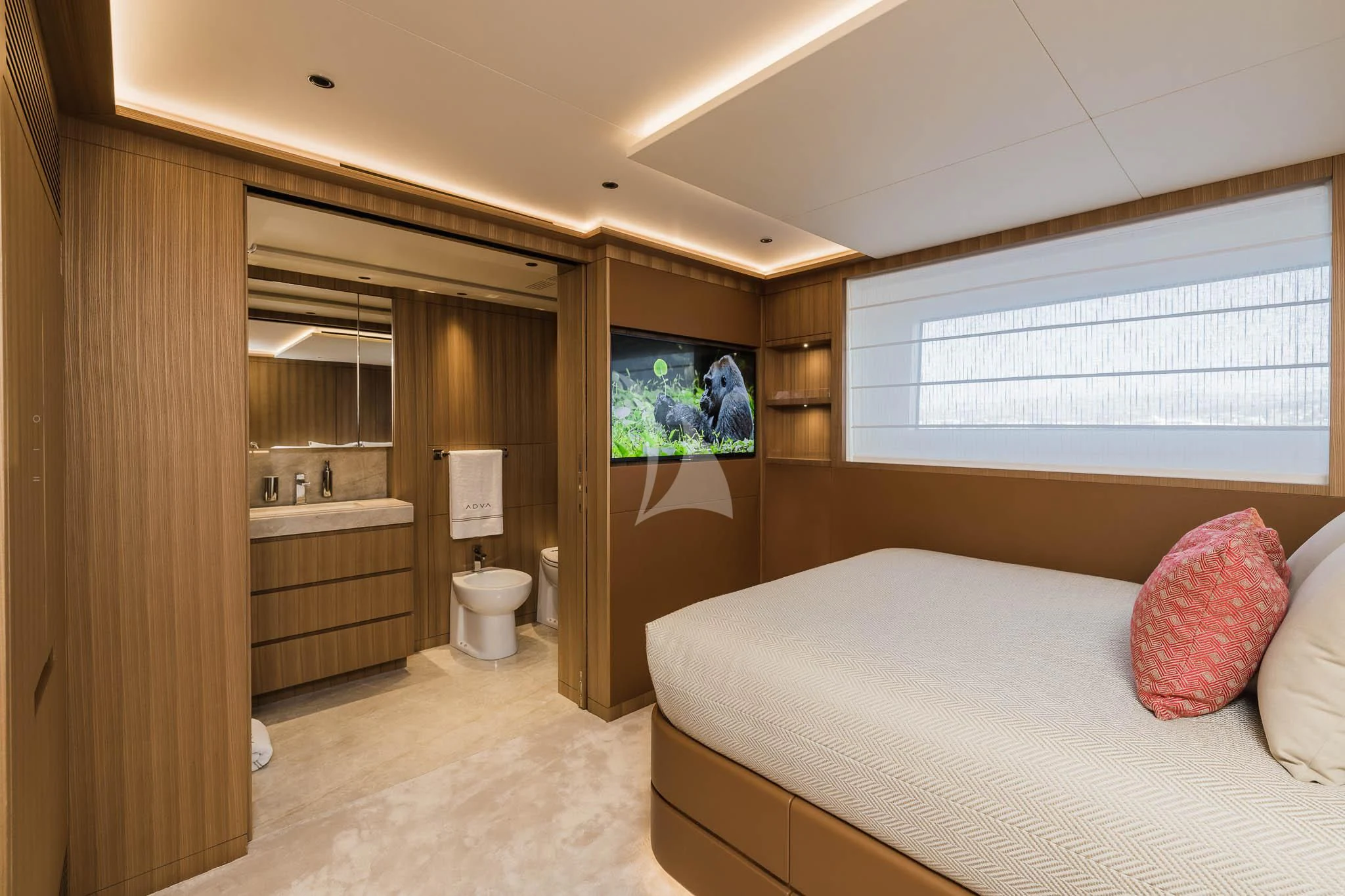 a bedroom with a bed and a mirror aboard ADVA Yacht for Sale