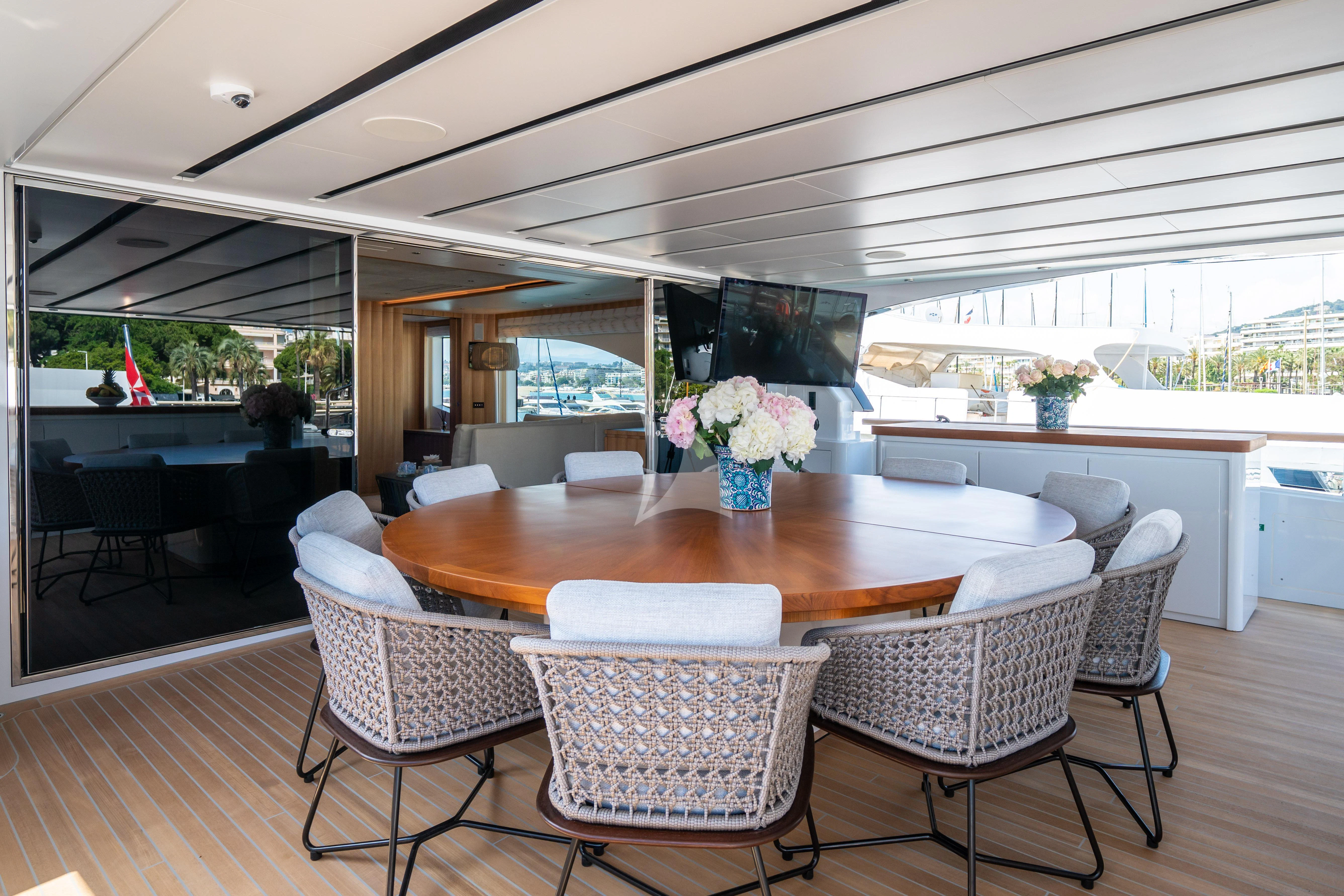 a large dining table with chairs around it aboard ADVA Yacht for Sale