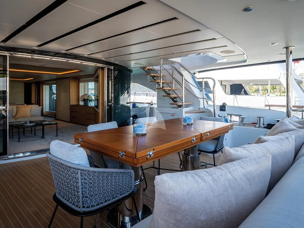a living room with a table and chairs aboard ADVA Yacht for Sale