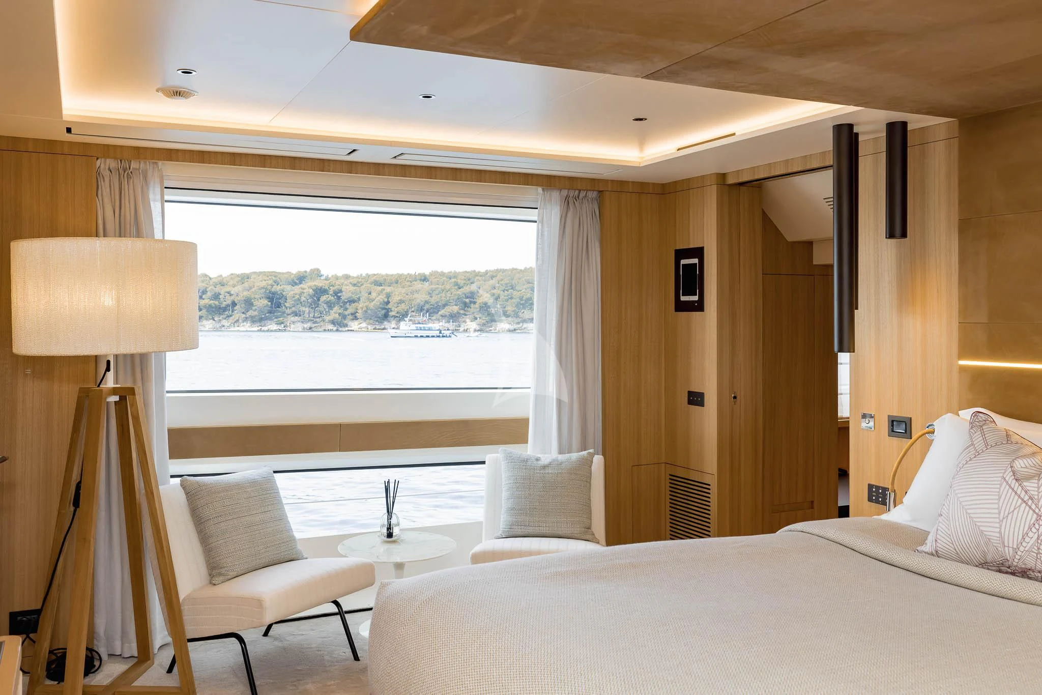 a room with a bed and a table and a window aboard ADVA Yacht for Sale