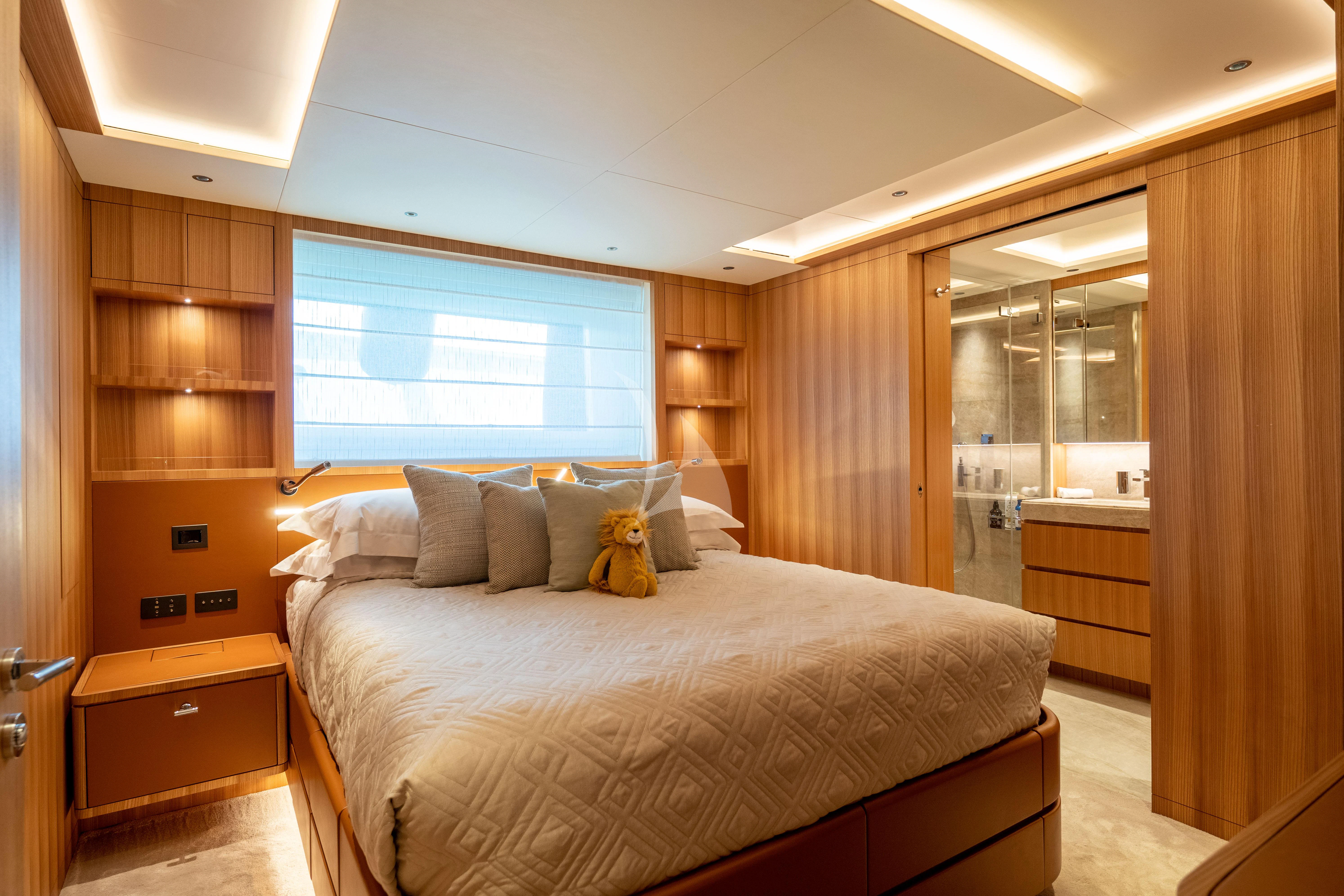 a bedroom with a bed and a desk aboard ADVA Yacht for Sale