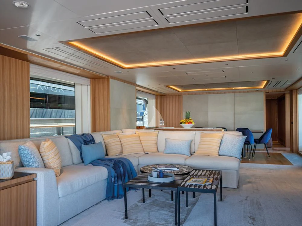 a living room with a couch and a table aboard ADVA Yacht for Sale