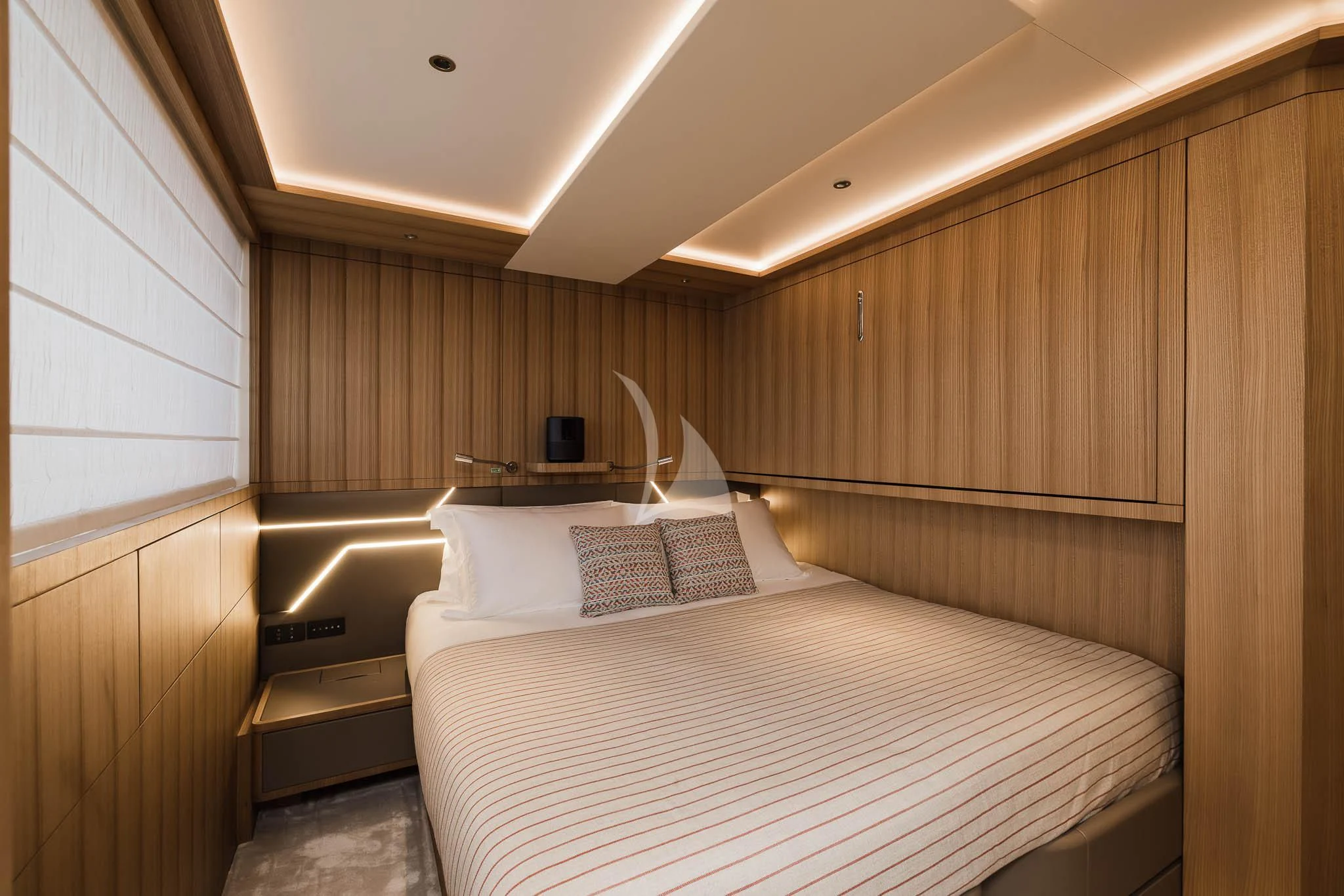 a room with a bed and a wood wall aboard ADVA Yacht for Sale