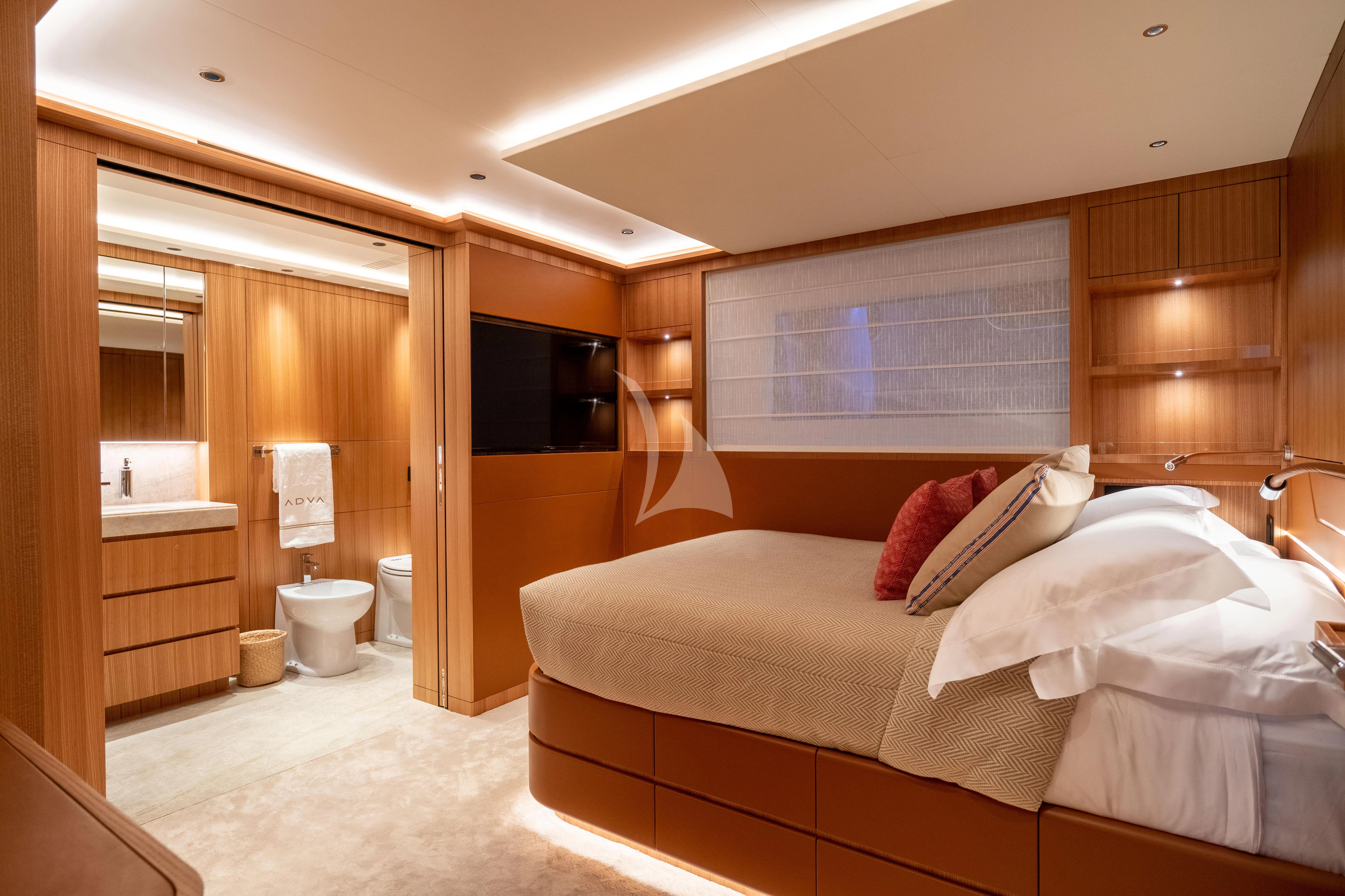 a bedroom with a bed and a mirror aboard ADVA Yacht for Sale