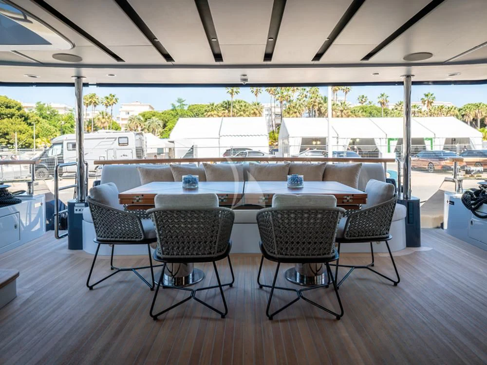 a table and chairs in a room aboard ADVA Yacht for Sale