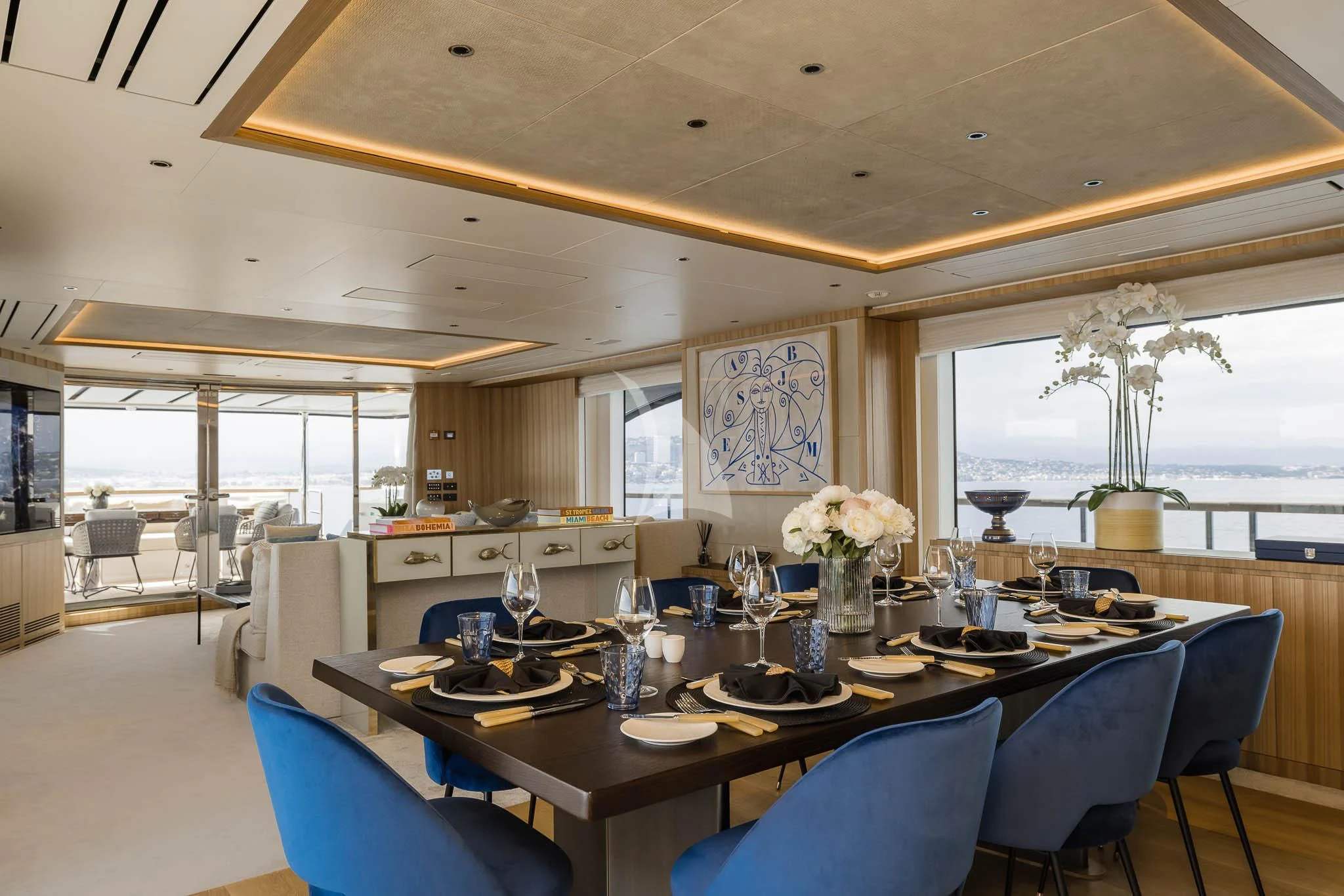 a large dining room with a large open kitchen and dining area aboard ADVA Yacht for Sale