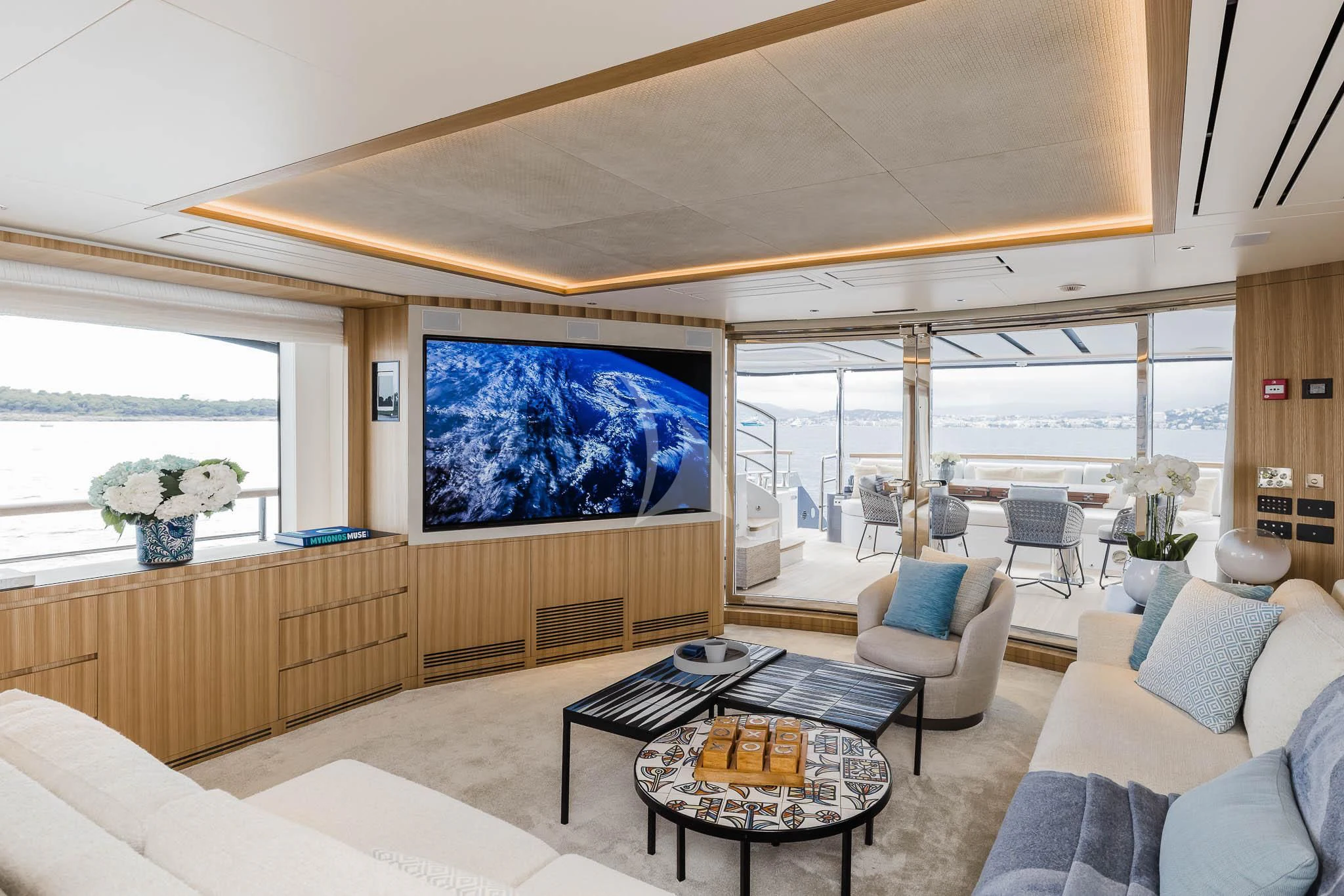 a living room with a large screen aboard ADVA Yacht for Sale