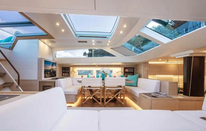 a modern living room with a large open window aboard MINDFULNESS Yacht for Charter