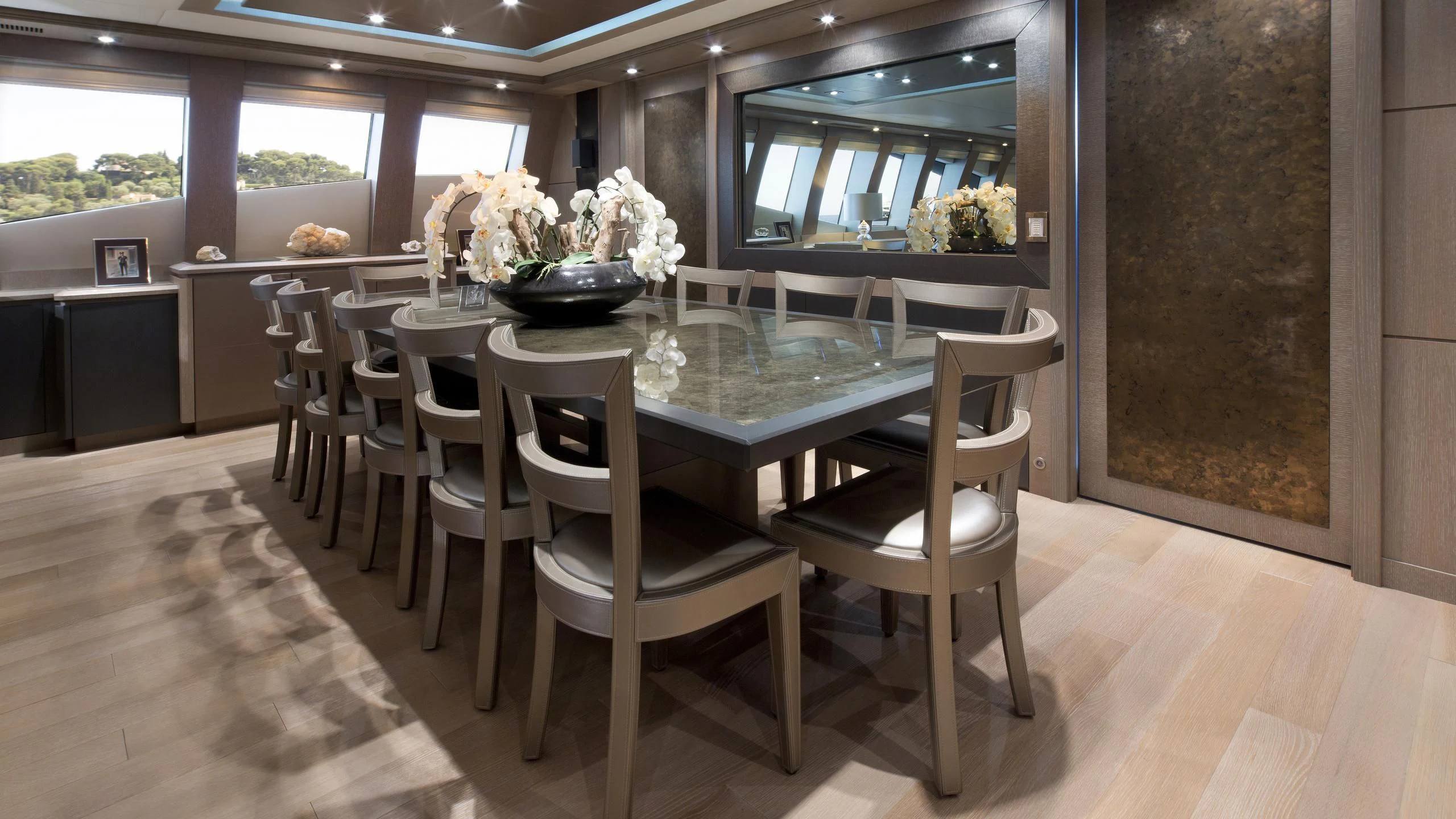 a room with tables and chairs aboard DEFIANT Yacht for Sale