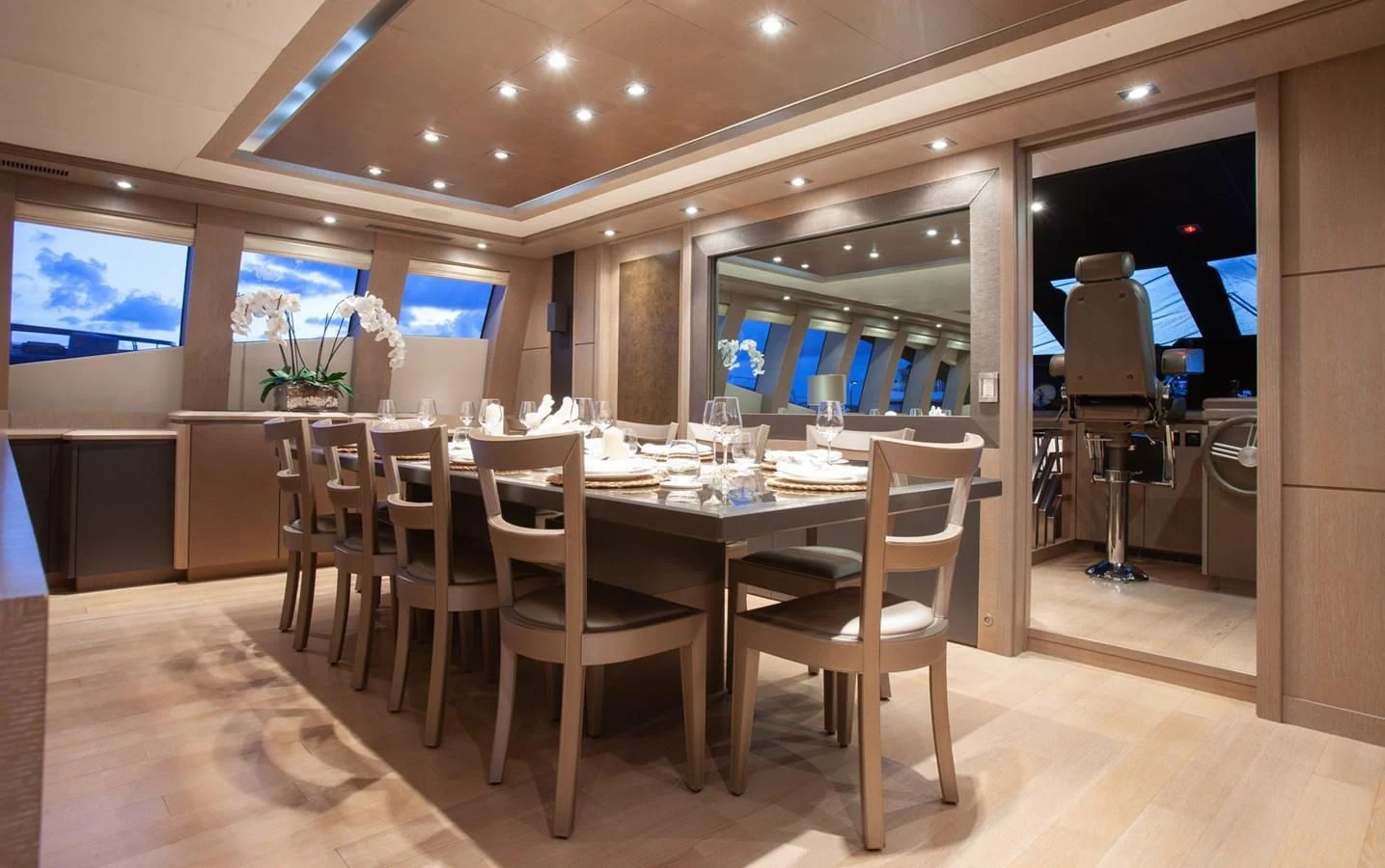 a room with tables and chairs aboard DEFIANT Yacht for Sale