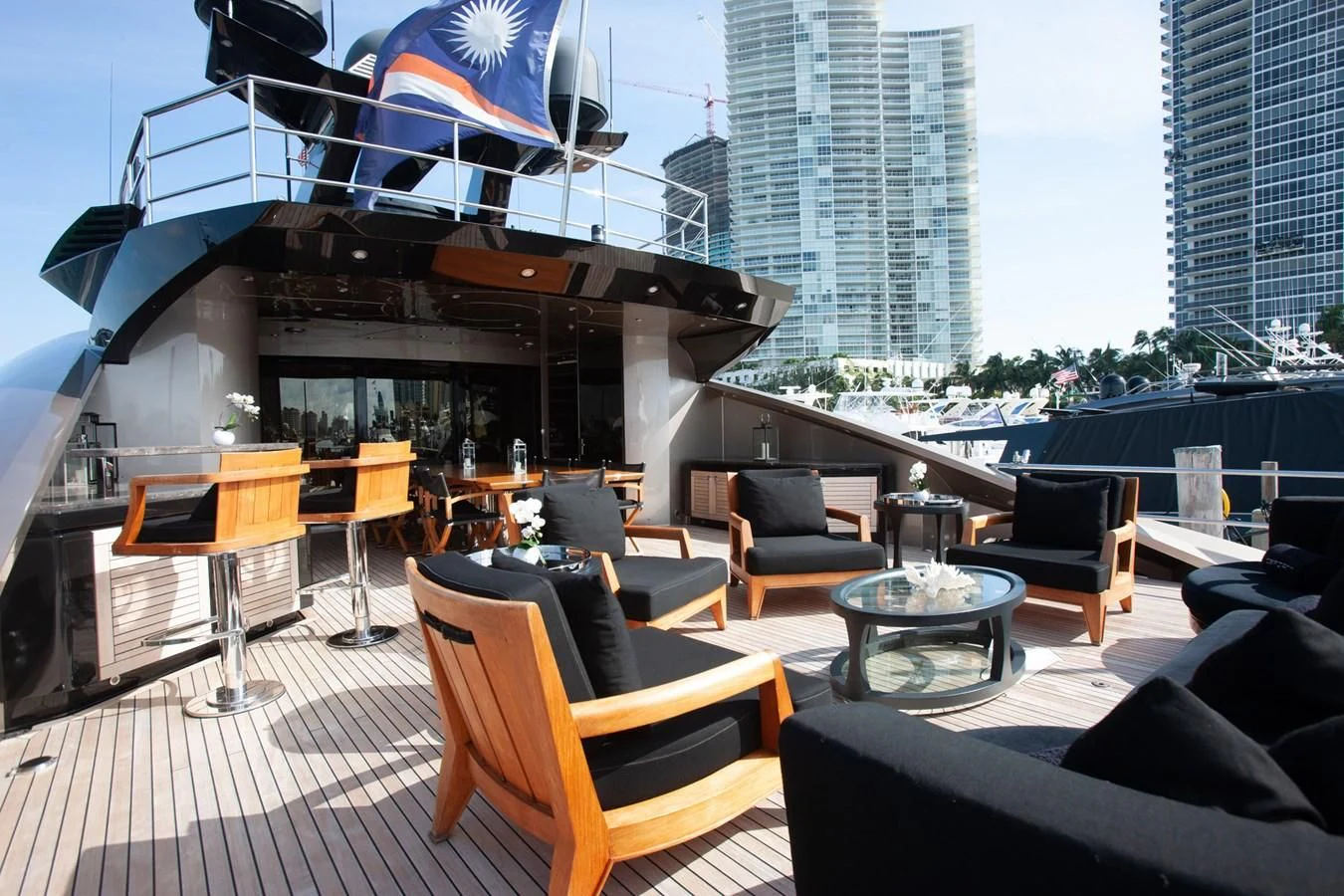 a room with a table chairs and a view of a city aboard DEFIANT Yacht for Sale