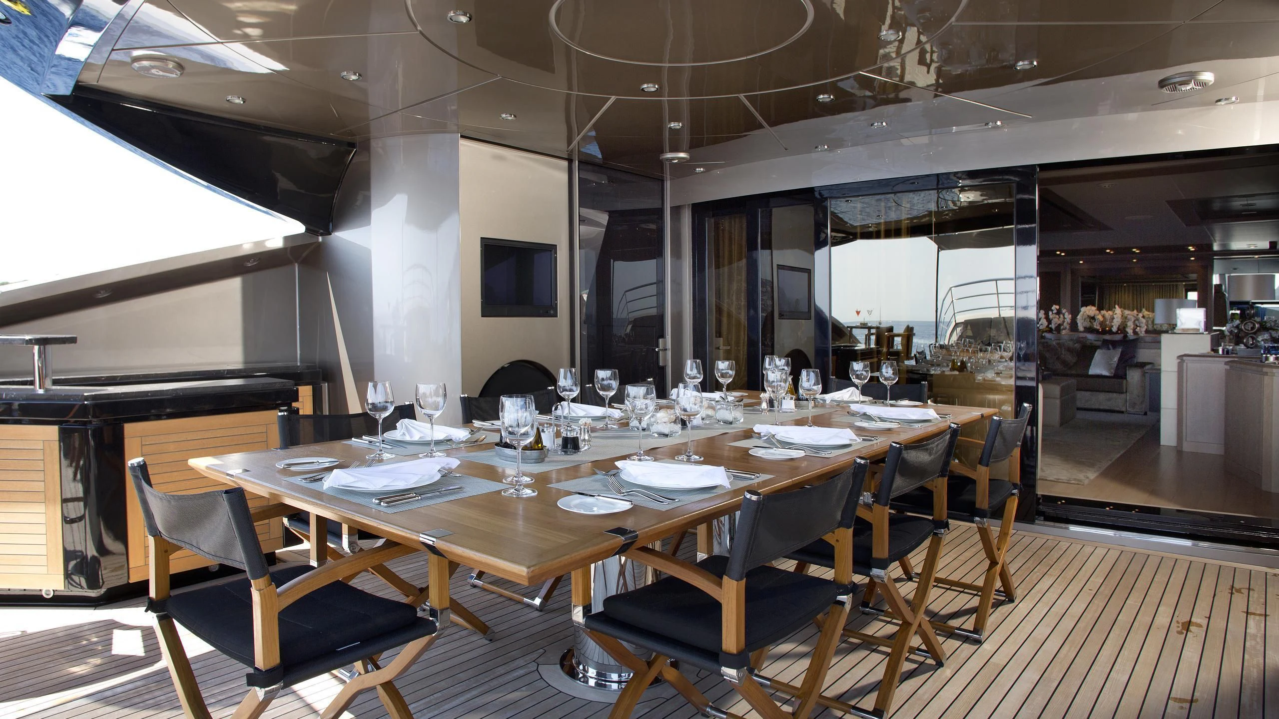 a large dining table in a room aboard DEFIANT Yacht for Sale