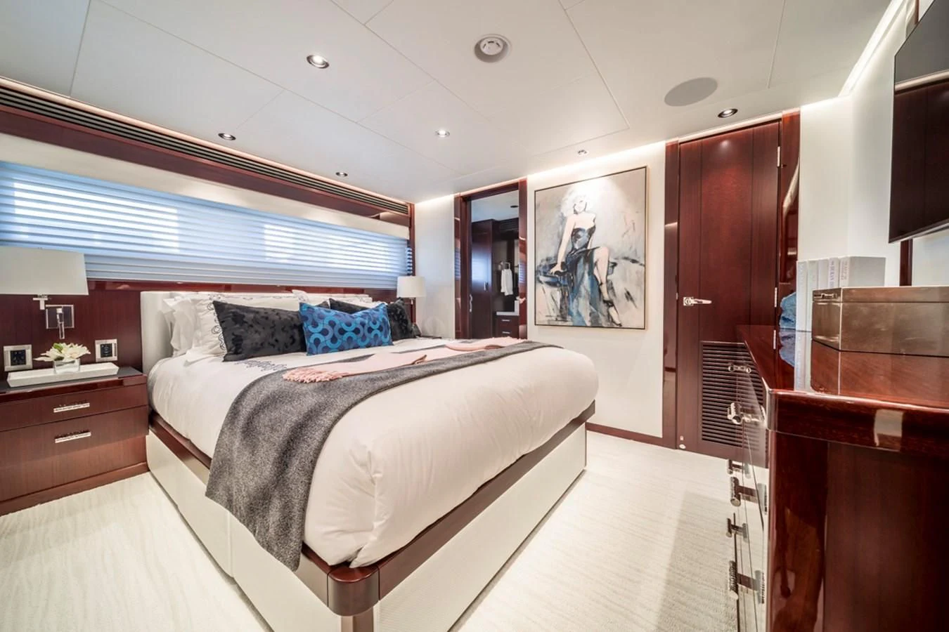 a bedroom with a bed and a desk aboard LION'S DEN Yacht for Sale