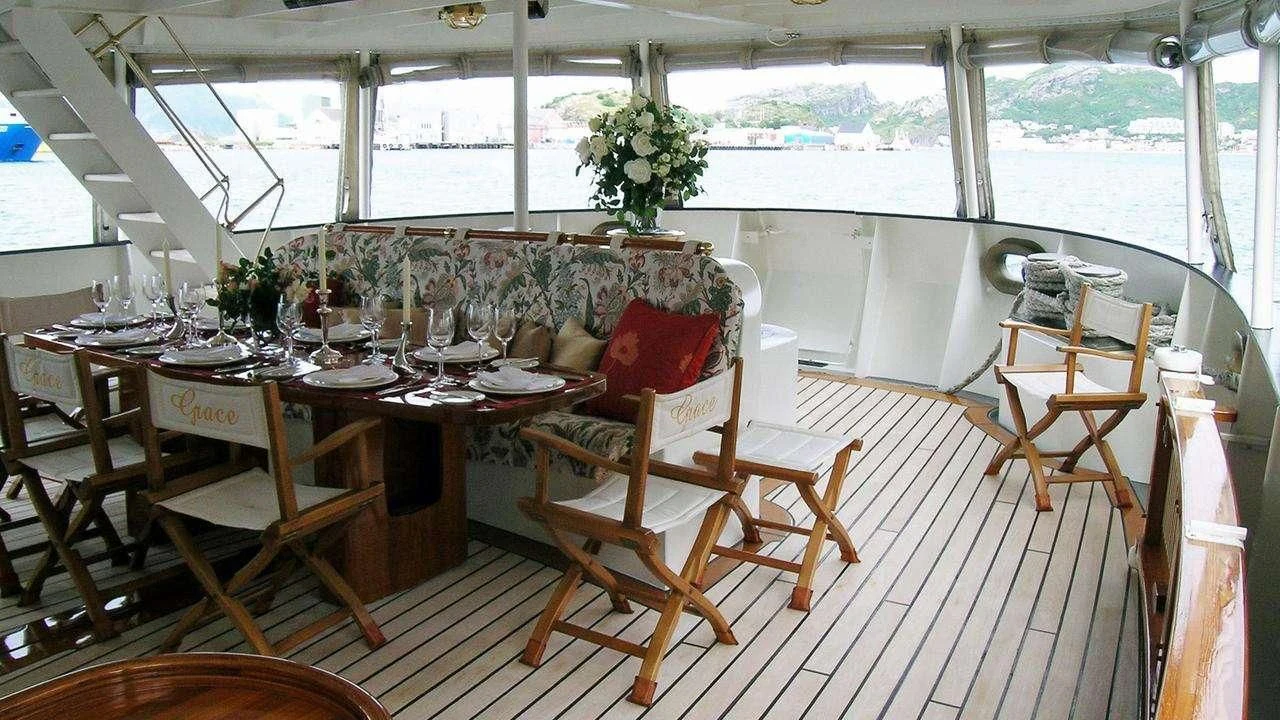 a room with tables and chairs aboard ELSA Yacht for Sale