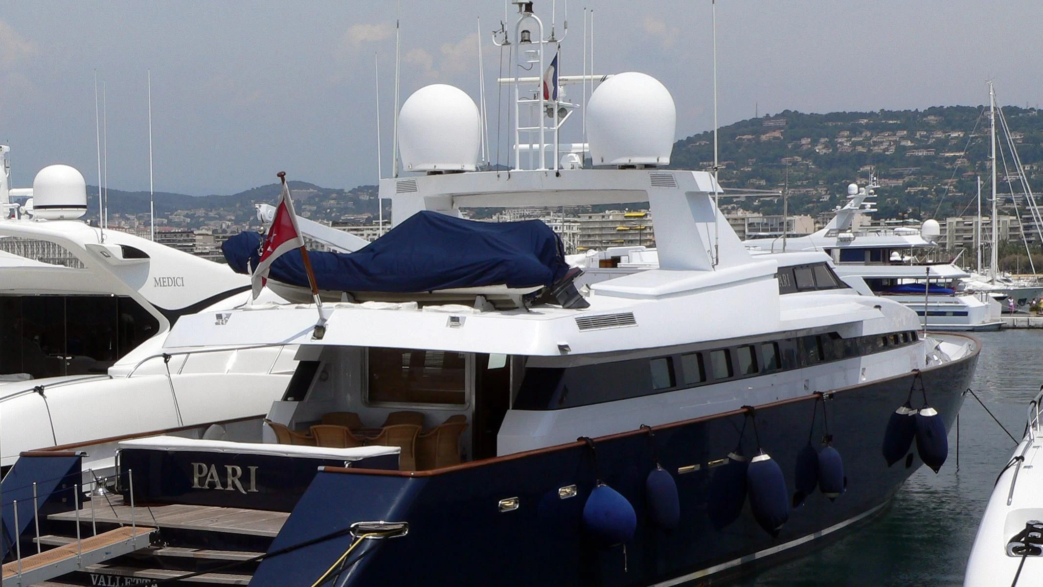 a boat docked at a pier aboard PARI Yacht for Sale