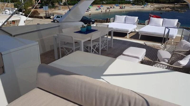 a room with a pool and chairs aboard MIRI Yacht for Sale