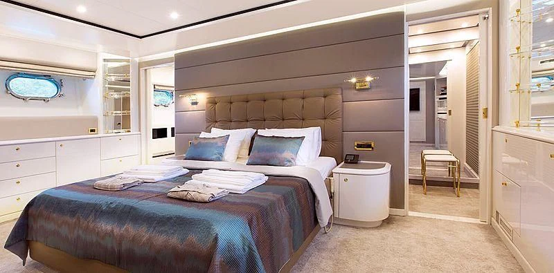 a bedroom with a bed and a desk aboard MEGI ONE Yacht for Sale