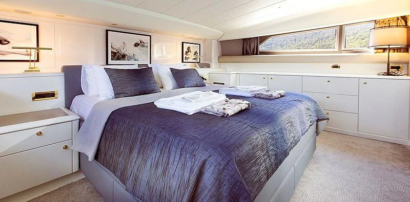 a bedroom with a bed and a desk aboard MEGI ONE Yacht for Sale