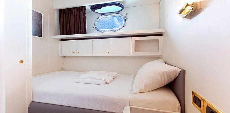 a bed with a white bed aboard MEGI ONE Yacht for Sale