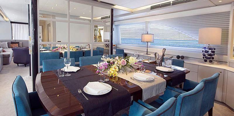a dining room with a table and chairs aboard MEGI ONE Yacht for Sale