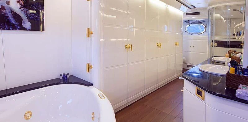 a bathroom with a tub sink and cabinets aboard MEGI ONE Yacht for Sale