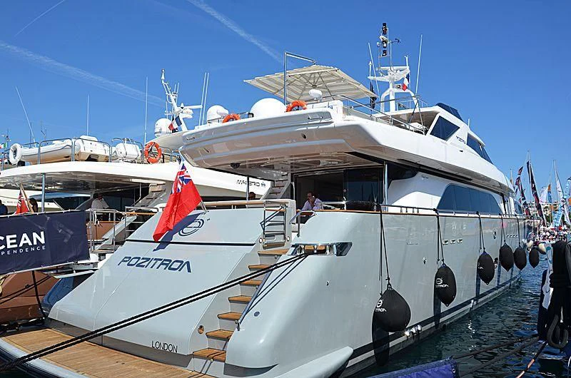 a large white boat with a red flag on it aboard MEGI ONE Yacht for Sale