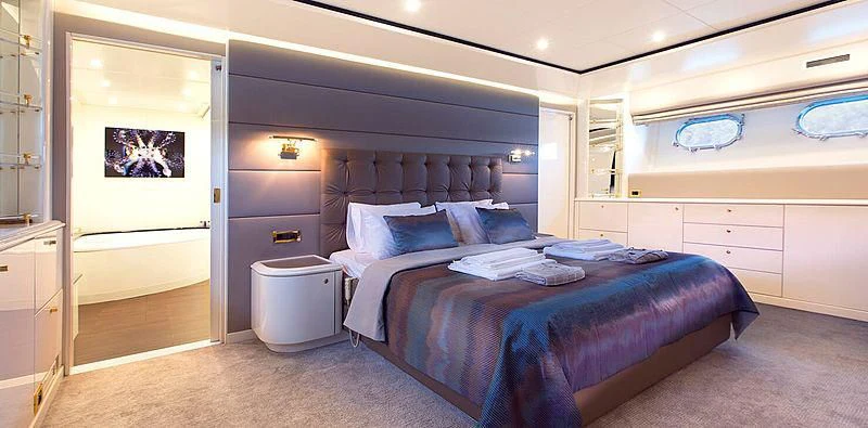 a bedroom with a bed and a dresser aboard MEGI ONE Yacht for Sale