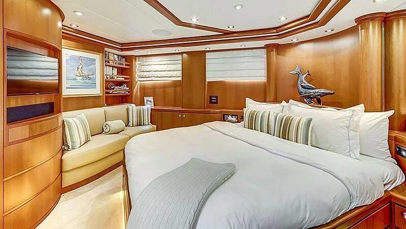 a room with a bed and a couch aboard GUSTO Yacht for Sale