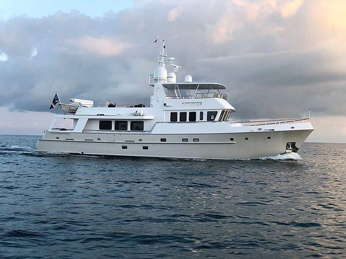 a large white ship in the water aboard GUSTO Yacht for Sale