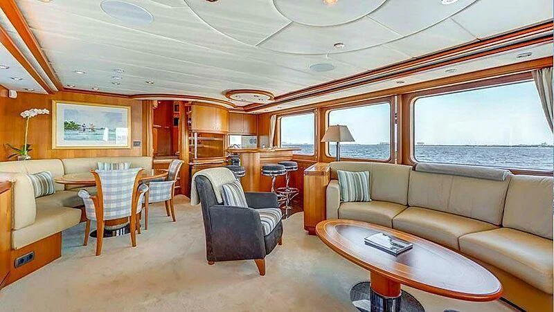 a living room with a couch and a table aboard GUSTO Yacht for Sale