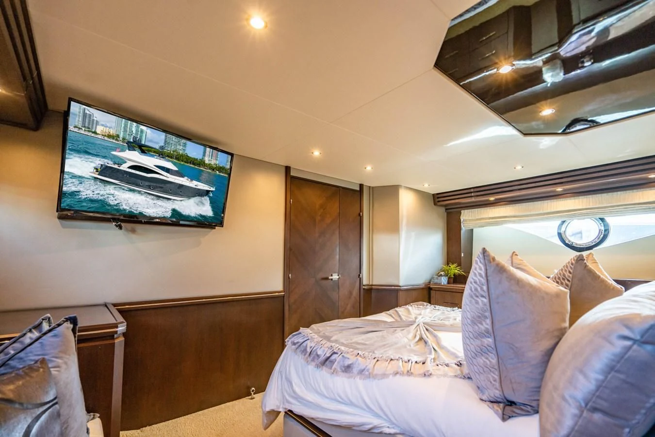 a bedroom with a large screen aboard MAYA Yacht for Sale