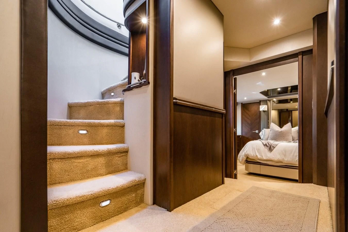 a wood staircase leading to a bedroom aboard MAYA Yacht for Sale