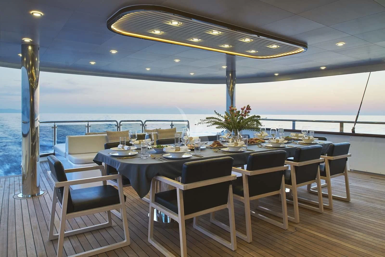a table set for a meal on a deck overlooking the ocean aboard ANIMA MARIS Yacht for Sale