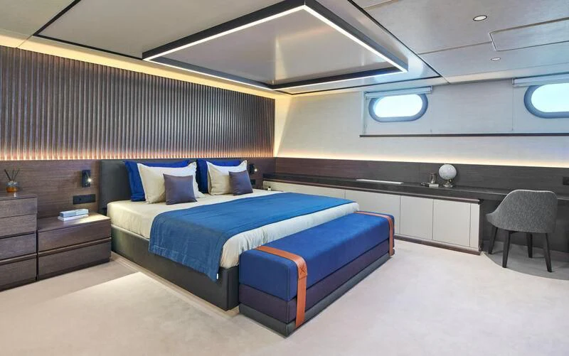 a room with a bed and a desk aboard ANIMA MARIS Yacht for Sale